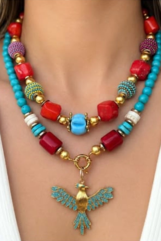 Turquoise and red coral beaded necklace with a turquoise-set brass phoenix pendant