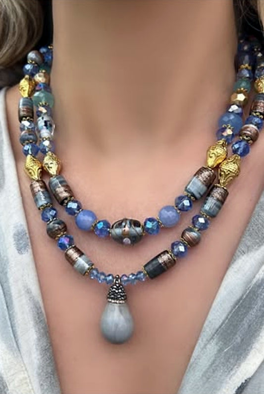 Two-strand blue and gold beaded necklace set with a smooth grey teardrop pendant