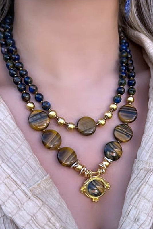 Two-strand tiger's eye necklace set with polished banded discs and a gold medallion